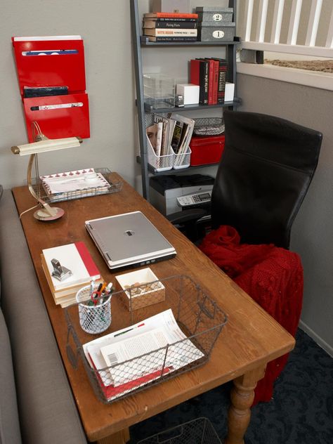 This gray home office space sits just off of the home's living room area and features a simple wood desk with a black leather chair. Pops of red from hanging organizers and a throw give the space a bit of color, while a metal bookshelf helps keep office items easily within reach. Office Without Windows, Designers Portfolio, Living Room Nook, Writing Room, Chic Office Decor, Red Office, Black Leather Chair, Metal Bookshelf, Grey Office