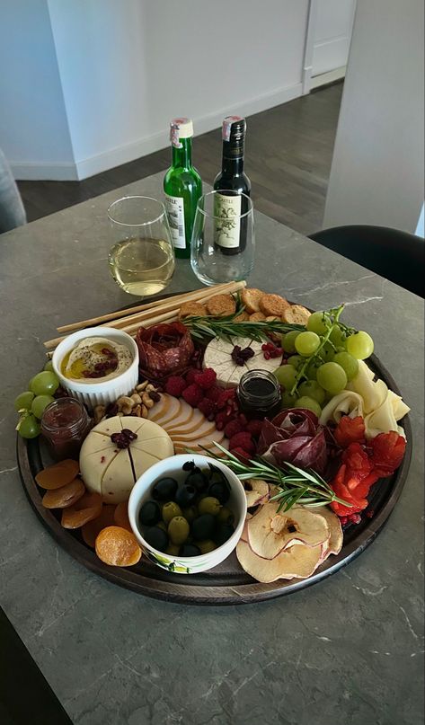 A charcuterie board composed of cheese, smoked meat roses, grapes, barries, olives and wine. #charcuterie #charcuterieboardideas #cheeseboard #cheeseboardideas Meat Roses, Cheese Charcuterie Board, Smoked Meat, A Charcuterie Board, Charcuterie Boards, Charcuterie Board, Hummus, Cheese Board, Grapes