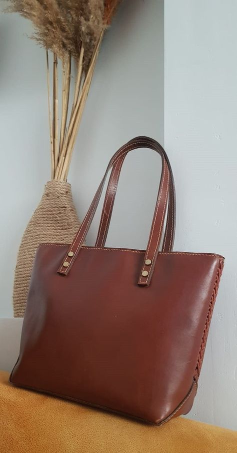 "handmade genuine leather styl: Daily handbag  \"Introducing our exquisite Leather Bag, meticulously handcrafted using premium-grade, eco-friendly cowhide leather that leaves minimum carbon footprint. This high-quality bag not only showcases impeccable artisanship but also carries the rich heritage of my country, reflecting its ethnic and cultural values. Imbued with sophistication and durability, this genuine leather daily handbag is a testament to timeless elegance. Its front measures 10,3 inc Premium Leather Handbags, Leather Work Bag, Large Leather Tote Bag, Daily Bag, Leather Sling Bag, Large Leather Tote, Leather Work, Best Bags, Work Bag