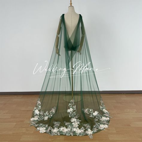 Item: Wedding Cape Veil Fabric: Tulle, Lace Color Of Tulle: Green(Pic Shows) Ivory White Beige Champagne Custom Color LENGTH: 26 inch 36 inch 54 inch 72 inch 90 inch 118 inch 137 inch 157 inch Custom length NOTE: *Main Tulle Color: white, beige, ivory and champagne, it is the main tulle color swatch link: (Link: https://www.etsy.com/listing/1221212350/veil-tulle-sample-tulle-color?click_key=b5749a7272768c61e01bc14184a7b3e722d75370%3A1221212350&click_sum=a44f64aa&ref=shop_home_active_1&frs=1&sts=1) If you want to custom color of tulle, i will send you color sample pic. Please contact me *We support custom veil: custom length and color, add blusher, add appliques/lace, make cape veil, hooded cape veil, mantilla veil. Please contact me about your thoughts of the veil. *We support custom veil: Boho Wedding Vails, Lord Of The Rings Themed Wedding Dresses, White Wedding Dress With Green Detail, Creative Veils, Loki Wedding, Fall Wedding Veil, Dark Green Wedding Veil, Green Wedding Veil, Lace Bridal Cape