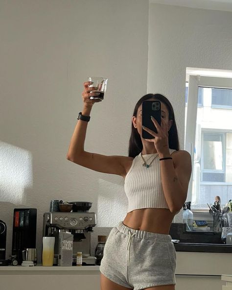 A girl wearing a grey short and a white tank top holding a cup of coffee. She has black hair and you can see a coffee machine and oat milk in the background Sporty Girl Aesthetic, Girls Stomach, Workout Pics, Healthy Inspiration, Sporty Aesthetic, Fitness Inspiration Body, Model Aesthetic, Healthy Girl, Healthy Lifestyle Inspiration