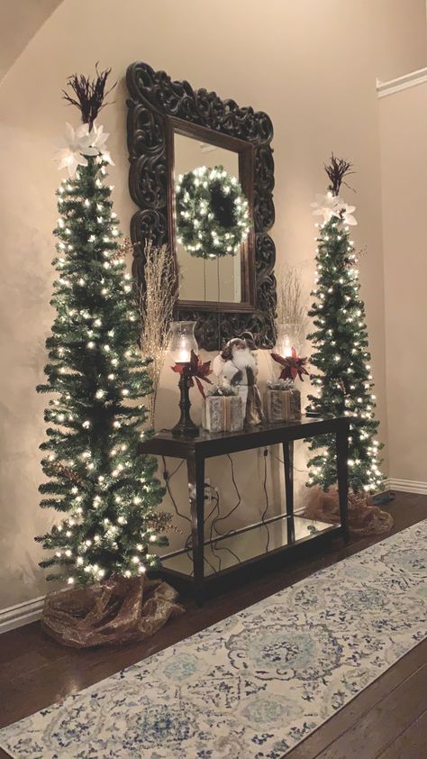 Christmas Entry Way Decorations, Cheap Christmas Decor Ideas For The Home, Sideboard Buffet Christmas Decor, Xmas Foyer Decorating Ideas, Western Flocked Christmas Tree, Neutral Living Room Christmas Decor, Hallway Christmas Tree, How To Decorate A Hallway For Christmas, Farmhouse Chic Christmas Tree