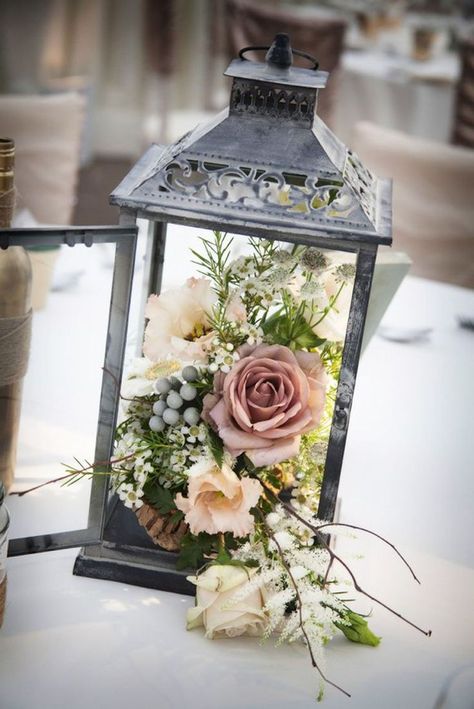 A rustic lantern–in place of a vase–adds a rustic touch to an outdoor party or wedding.  #homestyle #home #spring #homedecor #diy Container Arrangements, Lantern Centerpiece Wedding, Secret Garden Parties, Garden Party Theme, Deco Champetre, Country Garden Weddings, Tafel Decor, Lantern Centerpieces, Flowers And Greenery