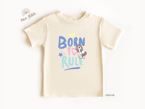 Delight your little one with our "Born to Rule" Rainbow Unicorn Toddler T-Shirt! Perfect for any unicorn loving girl, this cute and colorful top can be used for girls birthdays, special occasions, or just everday wear. Made from soft, comfy fabric, it's an adorable gift that's sure to bring smiles. 

For more of our designs: https://pixiestitchthreads.etsy.com Toddler Birthday Outfit, Unicorn Shirt, Girl Rainbow, Unicorn Tshirt, Toddler Birthday, Unicorn Gifts, Gift For Girls, Rainbow Unicorn, Unicorn Birthday