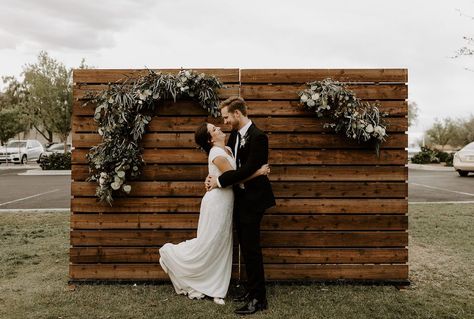 Our Wood Pallet Walls are one of our most popular inventory items! These versatile backdrops can fit any need. We have eight of these pallet wall backdrop rentals so rent as many as you need to create the necessary size of backdrop. Feel free to use nails, staples, or small screws to hang picture frames, greenery, floral arrangements, signage, and more. | Wood N Crate Rentals #arizonawedding #modernwedding #mesawedding #weddingrentals #palletwall Wood Backdrop Wedding, Wedding Photo Booth Rental, Pallet Backdrop, Wooden Backdrop, Simple Beach Wedding, Pallet Wedding, Wooden Backdrops, Wood Backdrop, Weddings By Color