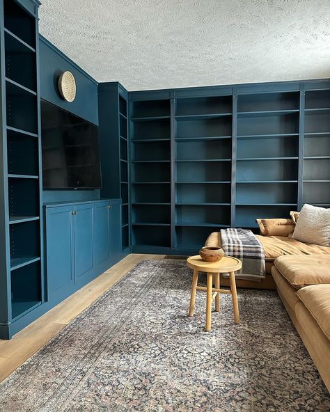 Happy Friday, friends! I realized I never shared photos of the living room library so I decided to jump in on #fridaysareforphotos cause it feels like OG IG days🙌 I clearly need more books😅 but am enjoying decorating with my antique and thrift finds! This room feels almost complete but tell me… do I need to paint the ceiling Hague Blue as well?🧐🤪 #livingroomlibrary #homelibrary #bookshelves #hagueblue #builtinbookshelves Dark Blue Built In Bookshelves, Living Room Library Ideas, Room Library Ideas, Paint The Ceiling, Builtin Bookshelves, Blue Library, Blue Bookshelves, Living Room Library, Hague Blue