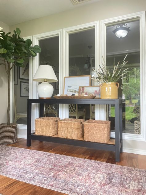 Table in front of windows, black console table, console table decor, console table styling, runner, entryway, entrway ideas Console Table In Front Of Window Decor, Console Table By Window, Table In Front Of Window Living Room, Console Table In Front Of Window, Black Console Table Entryway, Living Room Console Table Decor, Table In Front Of Window, Brass Lighting Fixtures, Mcm Credenza