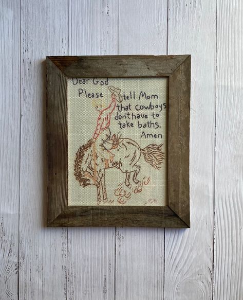 Dear God framed print is framed with barn wood. The picture is printed on fabric to look like it is stitched. The frame measures 14 1/2" x 12 1/2". The print is 8x10. Western Colonial Home, Bathroom Sign Decor, Vintage Cowboy Bathroom, Cowboy Nursery Art, Western Inspired Home Decor, Cowboy Theme Room, Modern Cowboy Nursery, Cowboy Nursery Ideas, Cowboy Room Boys