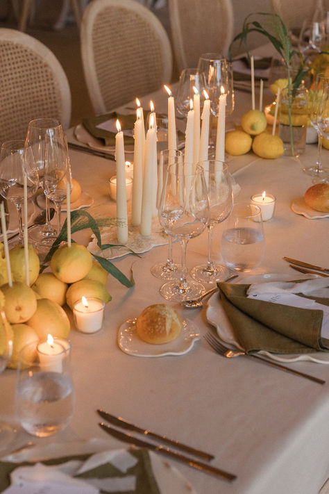 Elegant and cozy tablescape vibes 🍋✨ This Mediterranean-inspired wedding table is adorned with lush greenery, fresh lemons, and soft candlelight, creating a warm, intimate ambiance. The combination of ivory taper candles and earthy tones is perfect for a timeless and romantic setting. #WeddingTablescape #MediterraneanWedding #CandlelitDinner #ElegantDecor #ReceptionInspo Tuscan Table Decor, Cozy Tablescape, Mediterranean Tablescape, Candlelit Tablescape, Candle Tablescapes, Candle Table Setting, Tuscan Table, Cozy Wedding, Mediterranean Wedding