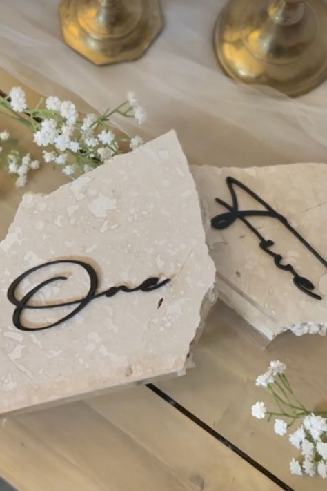 Acrylic clear bases, travertine, and black acrylic lettering. Stone Themed Wedding, Stone Seating Chart, Diy Stone Table Numbers, Stone Wedding Table Numbers, Fabric Table Numbers, Rock Table Numbers, Travertine Table Numbers, Diy Table Numbers Wedding, Stone Table Numbers