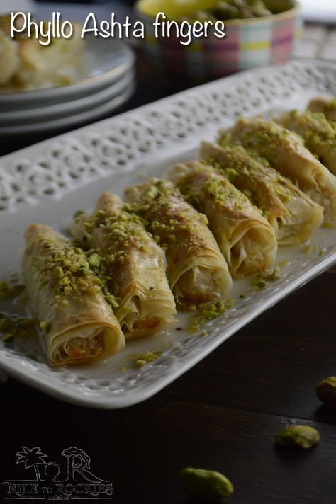 Sweet and soft buttery phyllo dough, wrapped around ashta creamy filling, a delightful Lebanese dessert. Ashta Fingers, Znoud El Sit, Phyllo Dessert, Ramadan Sweets, Phyllo Recipes, Lebanese Desserts, Pistachio Baklava, Arabic Desserts, حلويات عربية