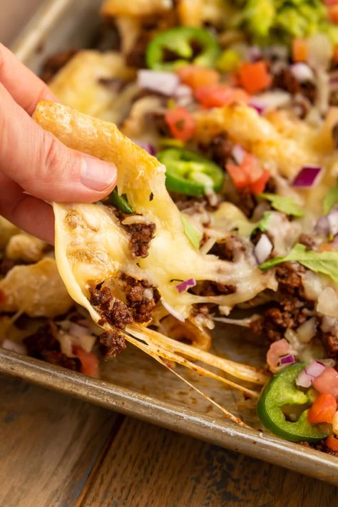 Fully-loaded pork rind nachos take traditional nachos and make them keto and low carb with a simple swap. A layer of pork rinds, taco spiced ground beef, plenty of cheese, guac, and your other favorite low carb Mexican toppings. This recipe makes a super quick, easy, and delicious dinner, or the perfect keto appetizer! Pork Rinds Low Carb Keto, Pork Rind Nachos, Keto Pork Rinds, Pork Rind Recipes, Taco Spice, Low Carb Mexican, Low Carb Tacos, Nachos Recipe, Pork Rinds