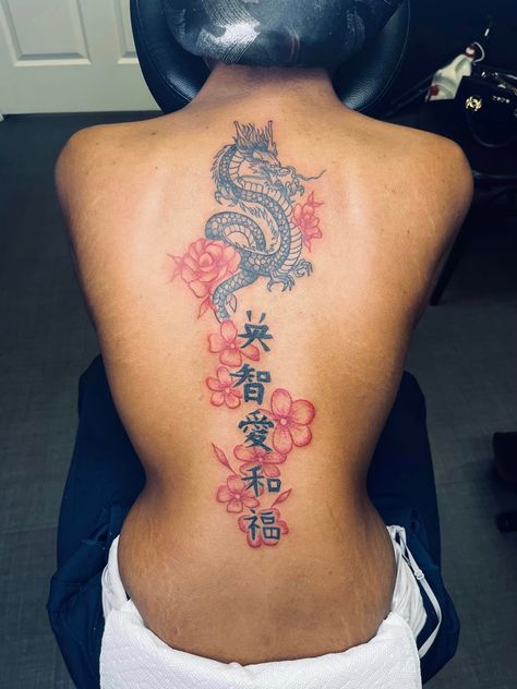 Dragon Spine Tattoo With Flowers, Back Red Tattoo Women, Chinese Dragon Spine Tattoo, Cherry Blossom Back Tattoo For Women, Creative Back Tattoos For Women, Spine Tattoos For Women Japanese Letters, Black And Red Spine Tattoo, Spine Tats Red Ink, Pink Back Tattoo