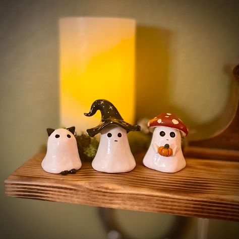 Add a playful twist to your Halloween decor with these adorable handmade  ghost figures, available in three unique styles: Ghost Cat, Ghost Witch, and Ghost Mushroom. Each figure is carefully crafted and hand-painted, bringing a touch of spooky fun and charm to your home. These ghostly characters are perfect for displaying on your mantel, shelf, or desk, adding a bit of festive spirit to any space. Whether you're a cat lover, a fan of all things witchy, or enchanted by the whimsical mushroom gho Cute Ghost Sculpture, Hand Built Pottery Halloween, Halloween Airdryclay Ideas, Mini Halloween Clay Ideas, Clay Ghost Tealights, Halloween Craft Gifts, Halloween Clay Figures, Clay Crafts Simple, Ceramic Halloween Decorations