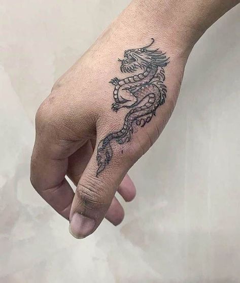 A intricate dragon tattoo by @elizabethftattoos- Creative thumb tattoos Hand Tattoos For Guys Dragon, Small Japanese Hand Tattoos, Lower Finger Tattoos, Finger To Arm Tattoos, Hand Tattoos Fire, Dragon On Finger Tattoo, Women Hand Tattoos Ideas Simple, Chinese Dragon Hand Tattoo, Dorsal Hand Tattoos