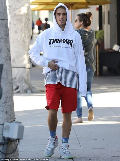 Showing off: The hitmaker wore a white Thrasher Skateboard Magazine sweatshirt that he lifted up to reveal a red, white, and blue striped shirt Hypebeast Fashion Men, Thrasher Sweatshirt, Justin Bieber Outfits, Justin Bieber News, Justin Bieber Style, Hypebeast Fashion, Thrasher Magazine, Justin Bieber Pictures, Love Justin Bieber