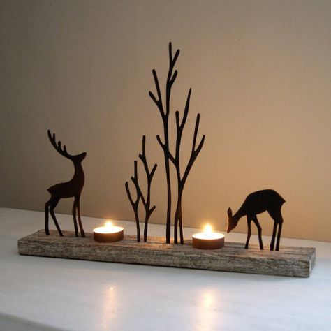 Charming seasonal tealight holder.Enchanting tealight holder with reindeer silhouettes in a woodland scene in rusty finish on a lime wood base. Quite stunning on mantle pieces and side tables as the silhouettes of the reindeer once the tealights are lit create wonderful shadows on the wall behind or just as lovely placed on a window sill as a welcoming glow for visitors.Metal and wood.28cm H x 40cm L x 7cm D Reindeer Silhouette, Silhouette Christmas, Woodland Scene, Scroll Saw Patterns, Tealight Holder, Christmas Wood, Light Holder, Christmas Deco, Tealight