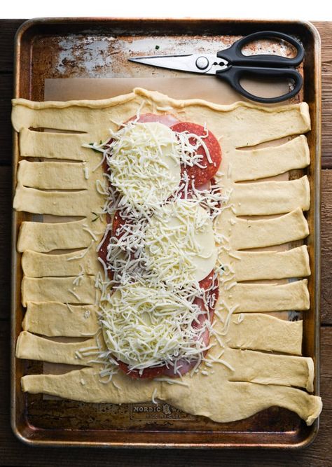 This easy Stromboli Crescent Braid has all of the Italian meats and cheeses that you love in a classic Stromboli recipe! Store-bought crescent roll dough is brushed with garlic butter, stuffed with ham, pepperoni, salami, Provolone and mozzarella, and then baked in the oven until it's puffy, flaky and golden brown. Serve the homemade Stromboli sandwich with a side of marinara for a quick dinner, a fun party appetizer, or a simple gameday snack! Crescent Dough Sheet Recipes, Crescent Braid, Cheese Stromboli, Easy Stromboli, Stromboli Recipe Easy, Homemade Stromboli, Crescent Dough Sheet, Stromboli Recipe, Pillsbury Dough