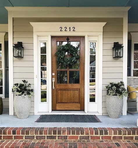 Haven’t worked on the front porch since December but when it’s March and 60 degrees...you get to it! Spring, we’re ready for you! Front Door With Lanterns, Decorate With Shutters Inside, Front Door Tudor Home, Front Door With Shutters On Each Side, Farmhouse Style Front Door, Wood Front Door Brick House, Front Door For Brown House, Front Door Farmhouse Entrance, Front Door Ideas Wood