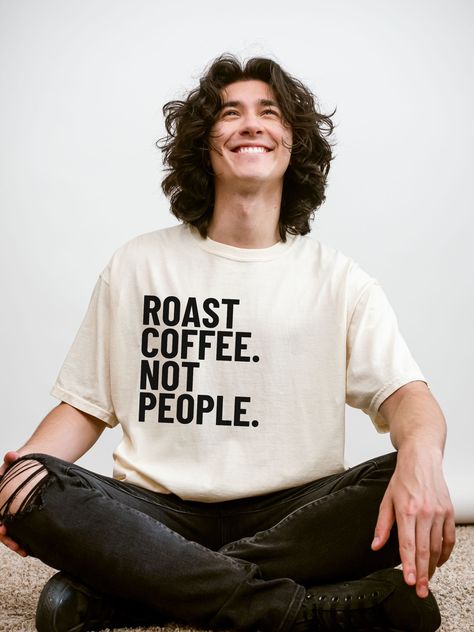 The best baristas and coffee roasters know - roasting coffee is way cooler than roasting folks. Brew some kindness in this 100% cotton garment-dyed tee, make to feel and look like a well-loved favorite. Great gift for baristas, coffee roasters, coffee professionals, or ya know, just kind people. SIZING Please review the size chart on the listing before you order so you can enjoy the best fit. We recommend taking your best-fitting tee at home, laying it flat, and measuring it from armpit to armpit. Compare those measurements with our size chart and use them to help you pick your size. Relaxed fit. For an oversized fit, we recommend sizing up. Please note that cotton is a natural fiber and there may be slight variations in color and size. DETAILS Design is direct-to-garment printed on a soft Cafe Tshirt Design, Coffee Shop Tshirt Design, Coffee Shirt Ideas, Coffee Shop Merch, Quotes Tshirt Design, Coffee T Shirt Design, Cafe Merch, Coffee Tshirt Design, Coffee Shop Shirt