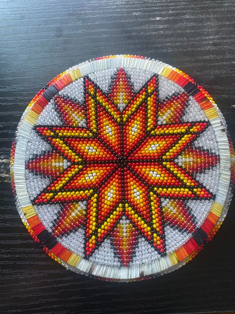 A beautiful traditional beaded medallion with a quill ring on a white background with red, orange, yellow and black. The medallion is 5in diameter Quill Work, Medallion Pattern Design, Beaded Madellion, Beaded Medallion Patterns Design, Beaded Medallion Patterns, Beaded Medallion, Native American Medallions Bead Patterns, Traditional Beaded Medallion Jewelry, Beaded Medicine Wheel Medallion