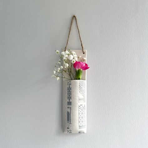 Elevate your indoor spaces with these unique handcrafted wall hanging pocket planters. Perfect for hanging on any wall, these porcelain hanging wall pockets provide a stylish and functional solution to showcase your favourite flowers.  This narrow version of the wall hanging pocket collection are perfect for 1 or 2 stems of foliage from the garden or from a bunch of flowers. They're also great for displaying herbs, air plants or dried flowers in and are completely water tight.    Handmade in por Large Wall Vase, Wall Hanging Ceramic Planter, Wall Hanging Vase, Wall Planter Ceramic, Ceramic Wall Pockets Ideas, Wall Pocket Ideas, Pottery Wall Pockets, Grey Architecture, Wall Vase Decor