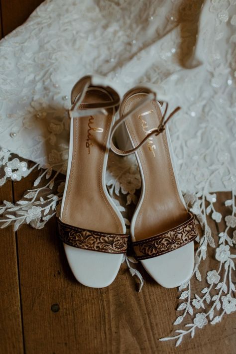 Beautiful hand tooled wedding or special occasion shoes. Made to order for your big day. Please let me know if you would like any specific personalizations added to the toe strap (namel, initials, brand, etc.). These heels are ordered when you put your order in, so please make sure you are aware of the processing time (it is 4-6 weeks in order to account for shipping delays).  Returns are not accepted as this is a custom item. Western Wedding Shoes Heels & Wedges, Rustic Wedding Shoes Brides, Winter Wedding Bridesmaid Shoes, Western Wedding Must Haves, Bridal Shoes Rustic Wedding, Wedding With Boots, Tooled Leather Wedding Shoes, Wedding Shoes Western, Western Heels Wedding