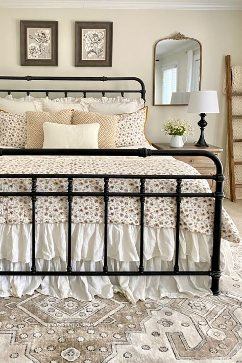 Summer farmhouse bedroom with neutrals and florals. A black iron bed, white and yellow floral bedding, and a neutral vintage inspired rug. Metal Bed Frame Bedroom Ideas Vintage, Summer Farmhouse Bedroom, Black Iron Bed, Black Iron Beds, Bedroom Ideas Black, Floral Farmhouse, Wrought Iron Bed, Black Bed Frame, Iron Bed Frame