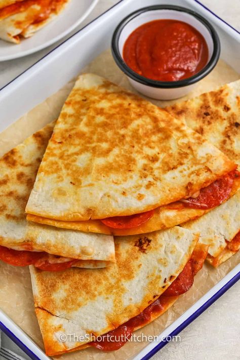 For a quick, tasty meal, or a yummy appetizer, try this pizza quesadilla! It’s made with flour tortillas, pizza sauce, melted cheese, and pepperoni, all cooked until golden and crispy. Serve with a side of extra pizza sauce for dipping, and you’ve got a delicious snack or dinner in minutes. Perfect for pizza lovers who want something easy to make and packed with flavor! This recipe is sure to be a hit. #theshortcutkitchen Recipes With Pizza Sauce, Tortilla Pizza Roll Ups, Tortillas Pizza, Pizza Roll Ups, Pizza Quesadillas, Pizza Quesadilla, Pizza Roll Up, Pizza Roll, Tortilla Pizza