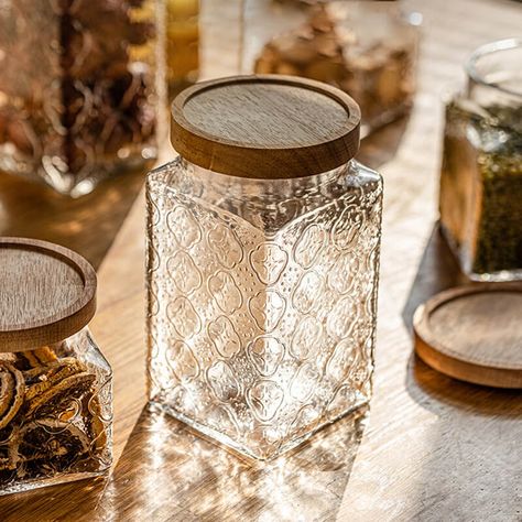 Introducing the Square Embossed Glass Storage Jar - a vintage-inspired, large capacity container perfect for storing a variety of items. Its strong sealing properties and intricate design elevate both your organization game and home decor. Upgrade your space with this timeless and elegant piece today! DETAIL - Item No: 202305ST53 - Material: Glass + Wood - Package include: 1/Pack Aesthetic Storage Containers, Cute Canning Jars, Glassware Storage Ideas, Pretty Jars, Aesthetic Home Decor Items, Glass Jar Packaging Design, Candy Jar, Glass Jar, Square Glass Jars