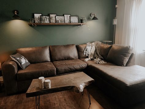 Green Living Room Brown Couch, Green Wall Brown Sofa, Dark Brown Coffee Table Living Rooms, Sage Green Living Room Brown Sofa, Green Wall Brown Couch, Dark Green Rustic Living Room, Green And Dark Wood Living Room, Green Living Room Brown Sofa, Brown Sofa Green Walls