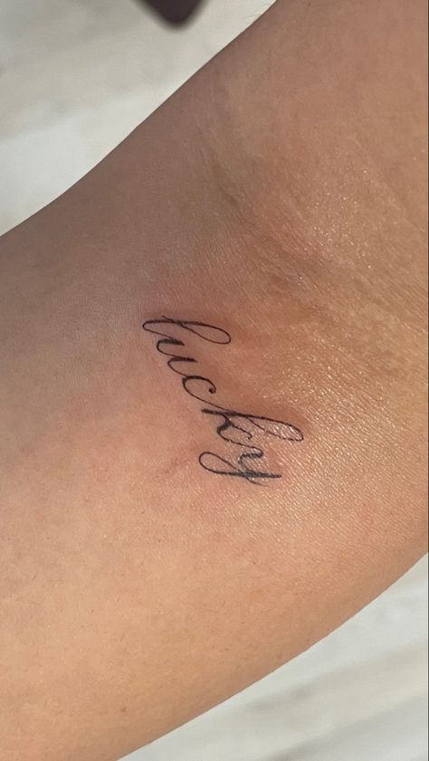 Tattoo Words For Woman, Lucky Cursive Tattoo, Make Good Choices Tattoo, Tiny Quote Tattoos For Women, Bliss Tattoo Words, Ethereal Word Tattoo, Paige Lorenze Tattoo, For Good Tattoo, Drake Inspired Tattoos