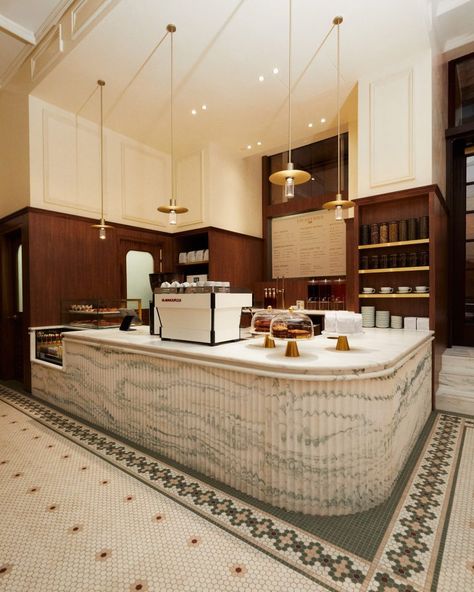 Kith Women Flagship in Soho combines walnut and pink marble Mosaic Floors, Service Counter, Cafe Counter, Bakery Interior, Kith Women, Custom Chandelier, Wrought Iron Gates, Room Display, Cafe Tables