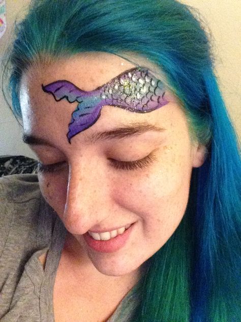 Mermaid tail face painting design by Kelsey, The Face Painting Lady! Mermaid Tail Face Paint, Simple Mermaid Face Paint, Mermaid Scales Face Paint, Facepainting Ideas Mermaid, Mermaid Stencil Face Paint, Mermaid Face Paint, Mime Face Paint, Ocean Design, Face Painting Easy