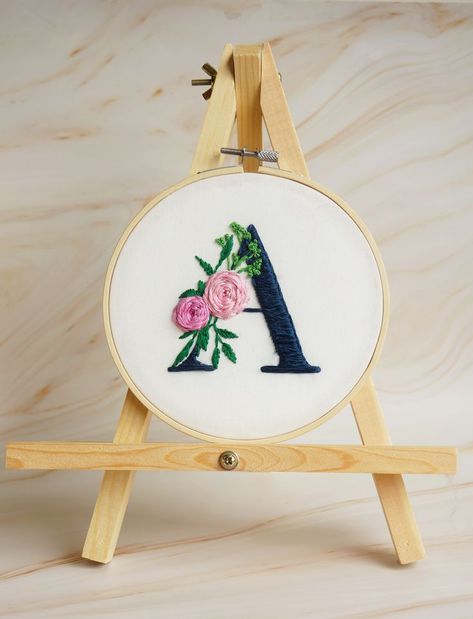 This personalized embroidery "A" letter design is hand stitched on quality cotton and neatly set into a bamboo hoop. - Handmade item. - Hoop diameter: 7 inch. - Shipping in USA. Please include the custom Initial (letter) you would like embroidered in the Personalization Box at checkout. heck out more embroidery designs in my shop: http://www.etsy.com/shop/SaliArtBoutique Let’s connect on Instagram @saliartboutique A Letter Design, Hoop Cross Stitch, Hand Embroidery Letters, Flowers Name, Name Decor, Calligraphy Art Print, Stitch Flowers, Name Embroidery, Floral Embroidery Patterns