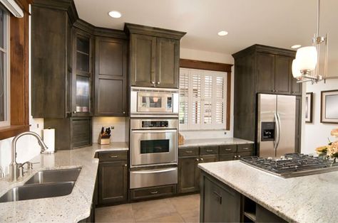 Interesting color makes up the cabinets in this custom kitchen design with a stainless steel wall oven and microwave on top. Wall Oven Kitchen, L Shaped Kitchen Designs, Small White Kitchens, Stained Kitchen Cabinets, Oven Cabinet, Kitchen Appliances Design, Wall Ovens, Cabinet Designs, Custom Kitchens Design