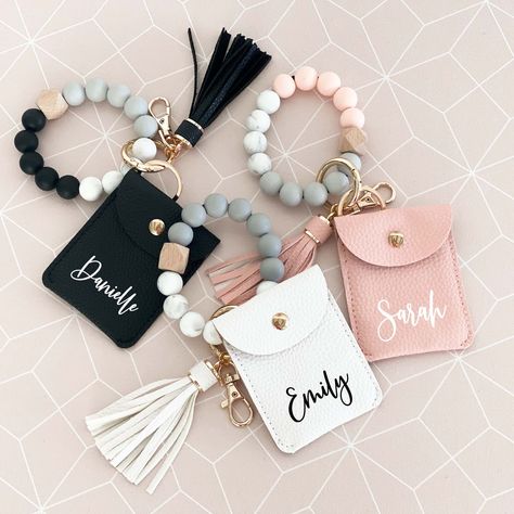 Personalized keychain wrist wallets are a cute gift idea for your bridesmaids or friends! Each wallet has a key ring, gold lobster clamp, fringe tassel, and wristlet bangle making it perfect to carry on the go. The small wallet is ideal for holding ID cards, credit cards, and cash. The stretchy wristlet has silicone beads making it soft and comfortable to wear. Choose from your choice of black or pink blush wallet with white text or a white wallet with black text. ★DETAILS★ This listing is for O Bangle Making, Anting Manik, White Wallet, Beads Making, Wrist Wallet, Bangles Making, Keychain Design, Wristlet Keychain, Personalized Gifts For Her