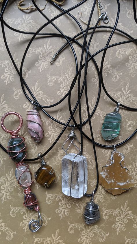 Variety of crystals on cords wrapped with sterling silver wire Wire Wrapped Raw Stone, Raw Crystal Wire Wrap, Wire Wrapped Raw Crystals, Wire Wrapping Raw Stones, How To Wire Wrap Crystals Tutorials, Crystal Necklace Diy Wire Wrap, Simple Wire Wrapping, Simple Wire Wrapped Pendant, Crystal Wire Wrapping