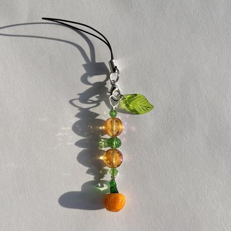 handmade pumpkin phone charm! handmade halloween... - Depop Fall Phone Charm Ideas, Halloween Beaded Jewelry Diy, Cute Handmade Halloween Jewelry, Handmade Halloween Necklace, Gelang Beads, Phone Charm Ideas, Halloween Phone Charm, Beaded Pumpkin Bracelet, Orange Keychain