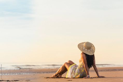 "Woman In A Dress With A Sunhat On Sitting On The Beach" by Stocksy Contributor "Cindy Prins" Woman On Beach Photography, Beach Portraits Woman Photo Shoot, Beach Portrait Poses, Sitting On Beach Pose, Beach Poses For Women, Women Beach Photoshoot, Varkala Beach Photography, Beach Sitting Poses, Beach Poses Dress