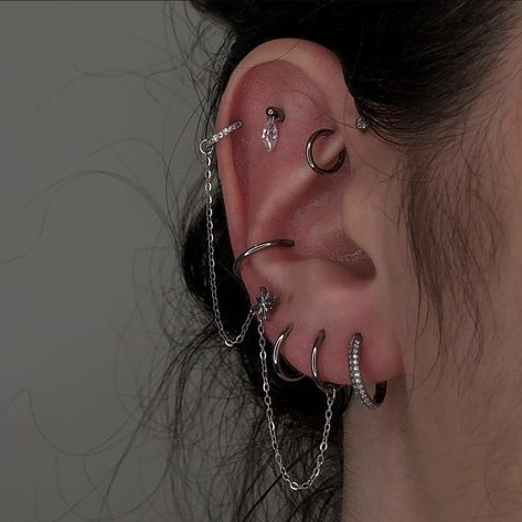 Goth Ear Curation, Pretty Industrial Piercing, Ears With Lots Of Piercings, Ear Piercing Ideas With Gauges, Silver Ear Curation, Edgy Ear Piercings Aesthetic, Ear Piercings Grunge, Alt Ear Piercings, Piercing Ideas Silver