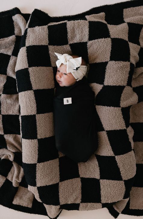 A baby wrapped in a black blanket is lying on a black and beige checkerboard-patterned blanket, adorned with the Bamboo Head Wrap | White + Black Bolt by forever french baby. The setting radiates coziness, evoking a sense of warmth and comfort. Country Baby Boy Nursery, Neutral Baby Blanket, Feather Yarn, Scrub Corpo, French Baby, Baby Bats, Bamboo Material, Baby Inspiration, Baby Must Haves