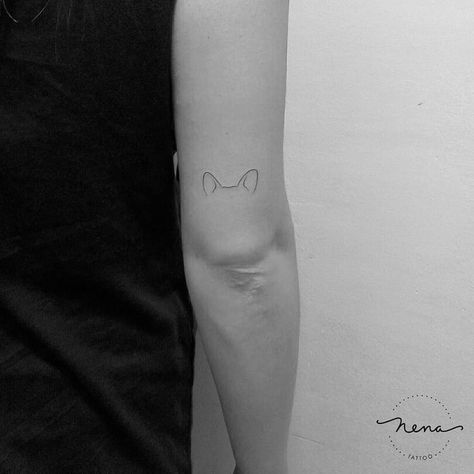 44 Tiny Minimalist Tattoo Designs by Nena Tattoo | TattooAdore Small Dog Ear Outline Tattoo, Corgi Ears Tattoo Minimalist, Minimalist Dog Ear Tattoo, Shiba Inu Ears Tattoo, Akita Tattoo Minimalist, Puppy Ears Tattoo, Dog Ears Tattoo Ideas, Dog Ears Fine Line Tattoo, Minimal Corgi Tattoo