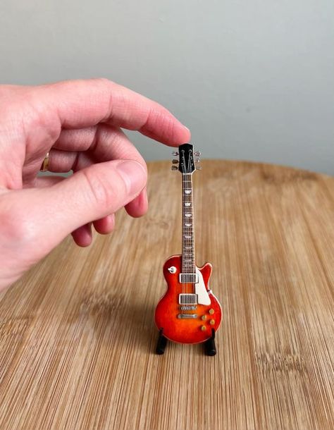 I made this 1:12 scale mini replica of my lifesize electric guitar! See how I made it on my instagram! #miniaturemodelmaking #miniatures #miniatureguitar #miniaturemaker #makeitmini #guitar Miniature Guitars, Mini Guitar, Mini Doll House, Miniature Projects, Miniature Diy, Diy Dollhouse Furniture, Handmade Miniatures, Be Cool, Model Making