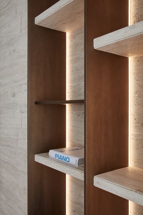 The shelf itself, meticulously crafted from high-quality materials, boasts a flawless, smooth surface that exudes sophistication. 

As you draw nearer, you notice the soft glow of strategically placed lighting that accentuates it. 

Warm, ambient light cascades gently downward, casting a gentle glow. Millwork Details, Luxury Architecture, Joinery Design, Cabinet Detailing, Shelving Design, Bookshelf Design, Shelf Lighting, Belek, Property Development