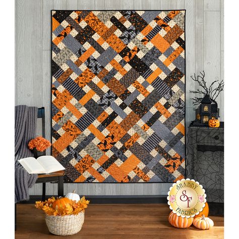 Add the perfect touch of Halloween fun to your home this year with the Picnic Quilt, designed by Cluck, Cluck Sew and recolored by Shabby Fabrics using the bewitching Nevermore collection from Andover Fabrics. The blocks are traditionally pieced and set on point, giving it a wonderful woven effect when sewn together. If you've never made an on-point quilt before, this is a great place to start! Finishes to approximately: 51" x 68". Kit Includes : Pattern All Fabrics for Top and Binding FREE US Shipping! Backing is not included, so don't forget to add it on in the options below! Products Used: Picnic Quilt Kit - Nevermore - 3-1/2 yds Backing - Perfect matching backing for this quilt. Measures approximately 3-1/2 yards. Creative Grids 6-1/2" x 24-1/2" Ruler - #CGR24 - Wonderful for fussy cut Halloween Quilts Patterns, Quilt Wall Hanging Patterns, Thanksgiving Quilt Patterns, Thanksgiving Quilt, Picnic Pattern, Red Quilts Ideas, Halloween Quilt Blocks, Autumn Quilt, Beginner Quilt