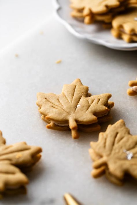 Easy and delicious maple leaf cookies, inspired by Canadian maple cookies filled with maple buttercream and simply decorated with edible gold. A wonderful treat for the fall season and for upcoming fall gatherings. Dairy free option included. Maple Leaf Cookies, Maple Buttercream, Maple Cookies, Leaf Cookies, Fall Gathering, Fall Mood, Edible Gold, Canadian Maple, Dairy Free Options