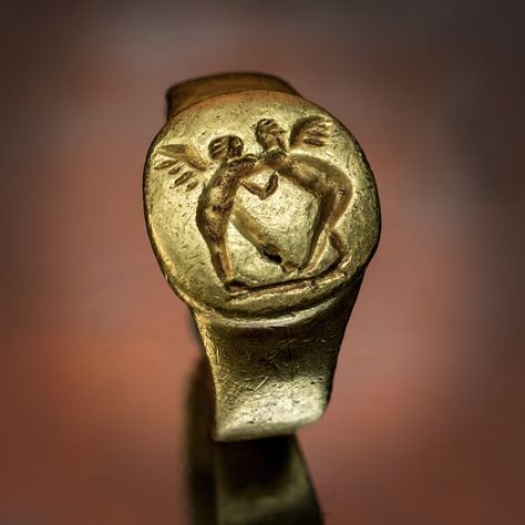 A unique, museum quality ancient Greek gold ring, circa 4th century BC, likely a wedding ring. The ring is chased and engraved with two wrestling Erotes. Ancient Greek Jewelry, Greek Ring, Ancient Jewels, Ancient Jewellery, Ancient Greek Art, Historical Jewellery, Medieval Jewelry, Greek Jewelry, Gold Signet Ring