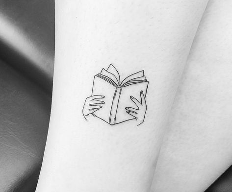 Hands Holding Book Tattoo, Book Tattoo Small Simple, Book Heart Tattoo, Hand Holding Book Tattoo, Tattoos For Bookworms, Book Club Tattoo Ideas, In Libris Libertas Tattoo, Fine Line Tattoo Book Lover, Reading Inspired Tattoos