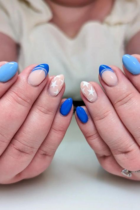 These almond-shaped nails are a charming ode to subtlety and style. They feature a soft, sheer base with delicate white stars scattered across, providing a gentle contrast. A bold touch of cobalt blue adds a pop of color with both full coverage and an angular French tip design. The look is fresh, playful, and perfectly suited for a festive celebration. 🌟✨  // Photo Credit: Instagram @starfruitnails Subtle 4th Of July Nails Almond, 4th Of July Nails Almond, July Nails Almond, Blue Stiletto Nails, Short Oval Nails, Oval Shaped Nails, Festive Nail Designs, French Tip Design, Fourth Of July Nails